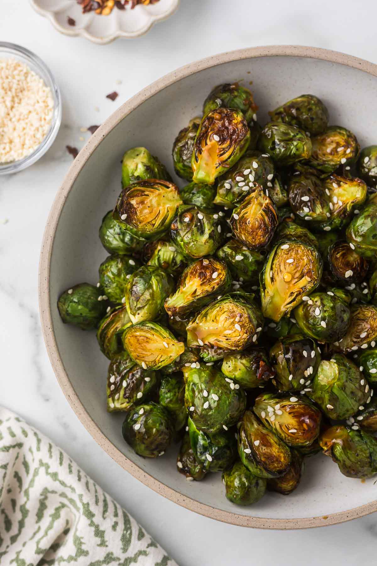 A bowl of Teriyaki Brussels Sprouts with sesame seeds.