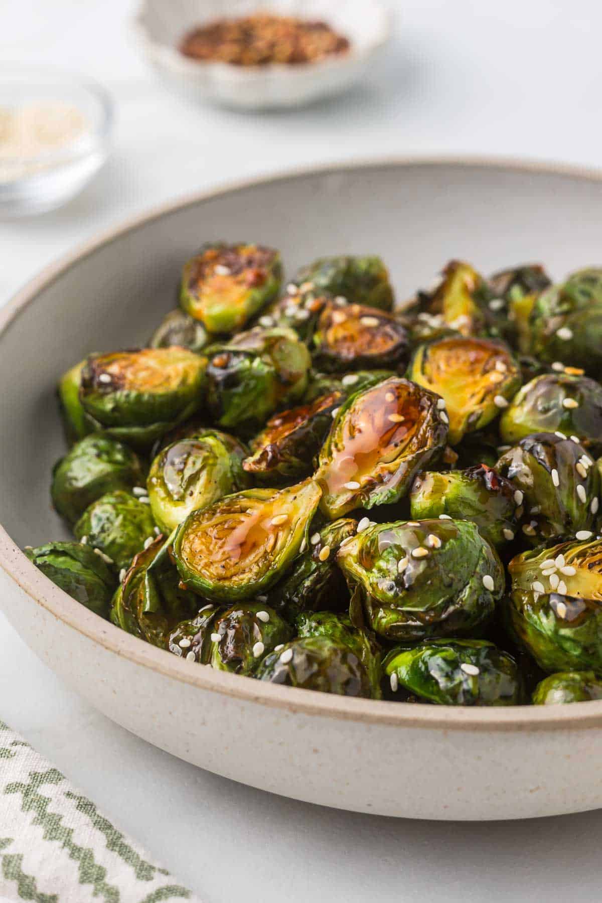 A bowl of roasted Brussels sprouts with a teriyaki glaze.