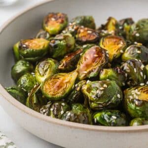 Brussels Sprouts with Teriyaki sauce and sesame seeds in a serving bowl