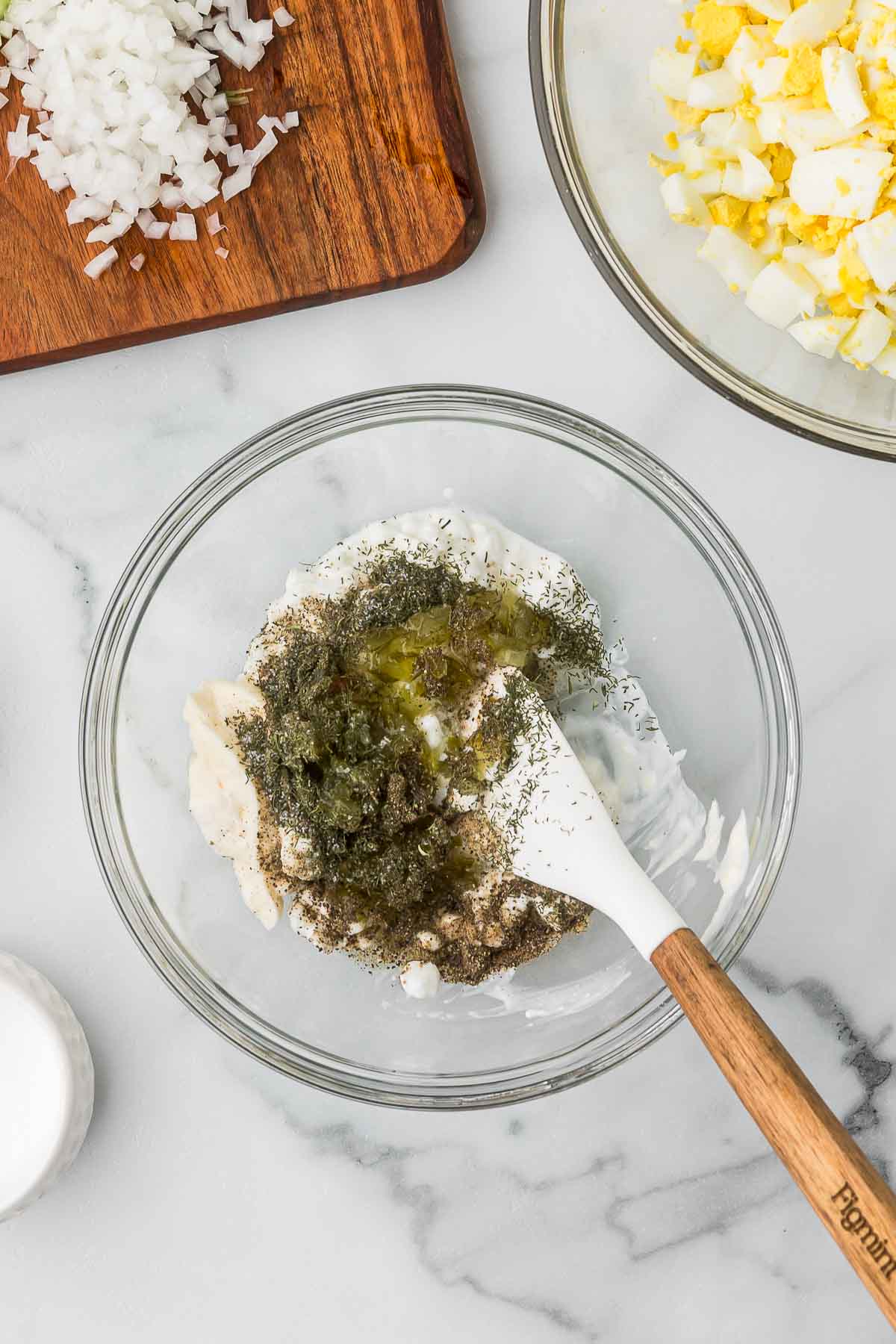 A bowl with the dressing ingredients to make egg salad with cottage cheese.