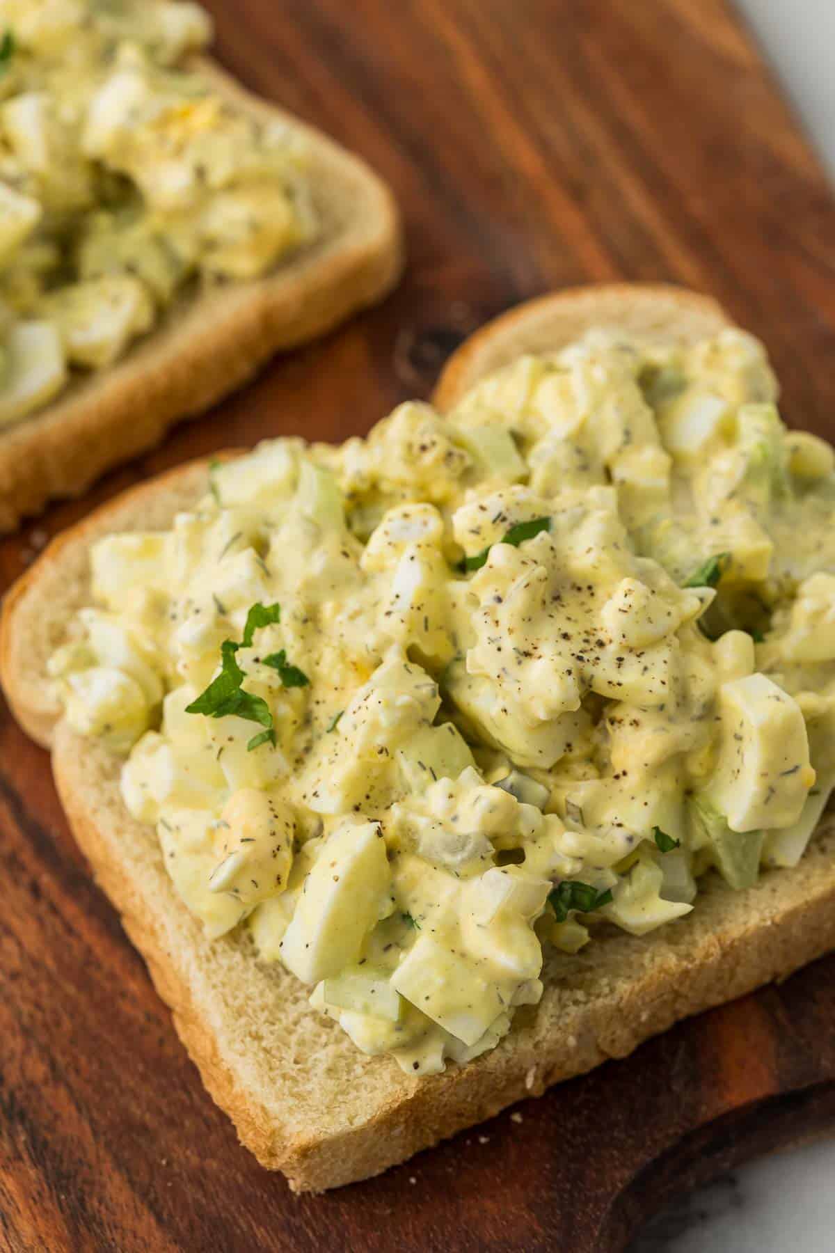 Cottage cheese egg salad on a piece of bread with parsley and black pepper.