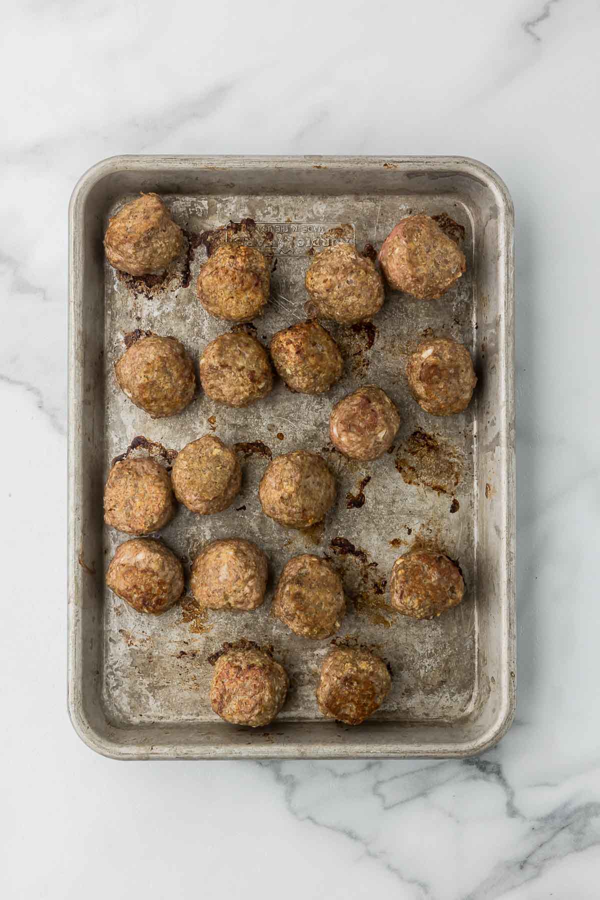 Turkey meatballs after they have been baked on a sheet pan.