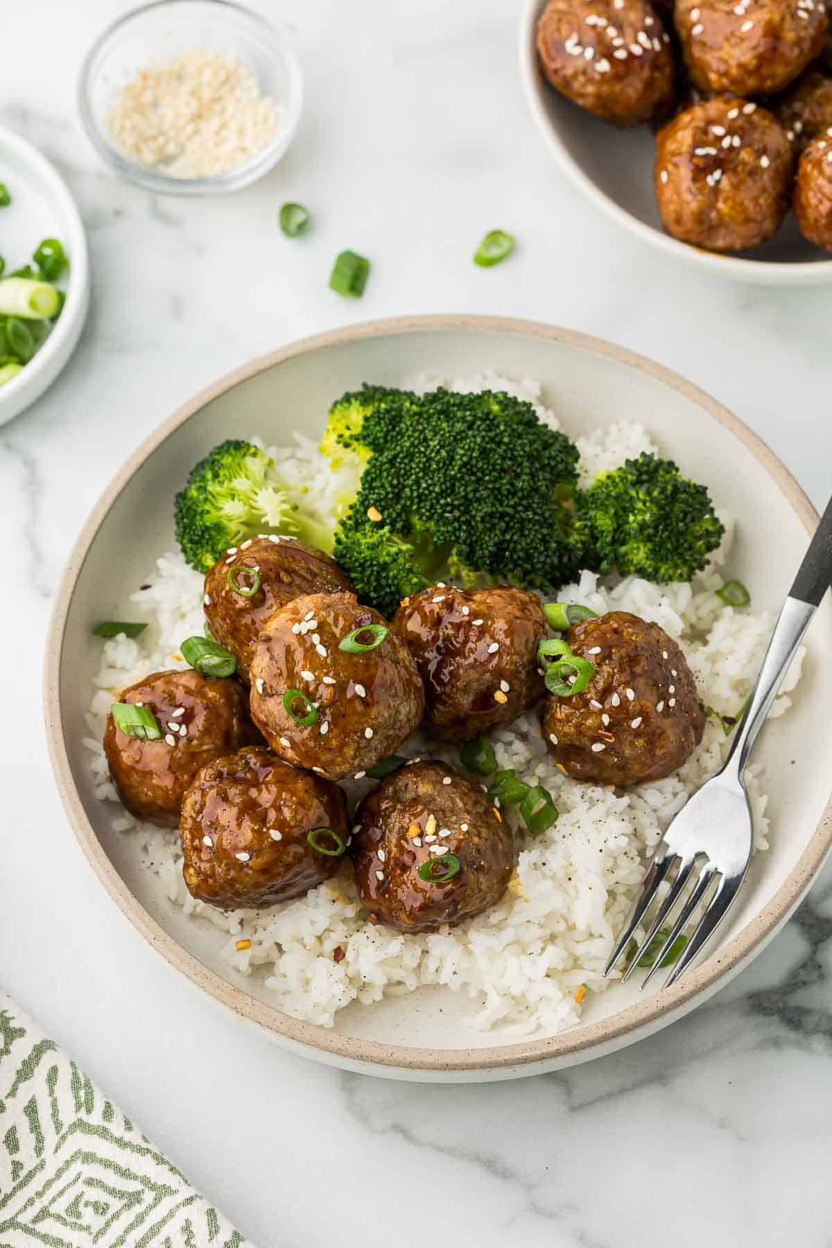 Teriyaki Turkey Meatballs in a bowl with rice and broccoli.