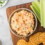 Homemade pimento cheese in a bowl served with celery and crackers.