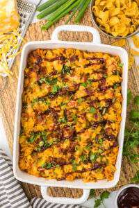 Leftover BBQ Chicken Casserole with cilantro as garnish in a white casserole dish.