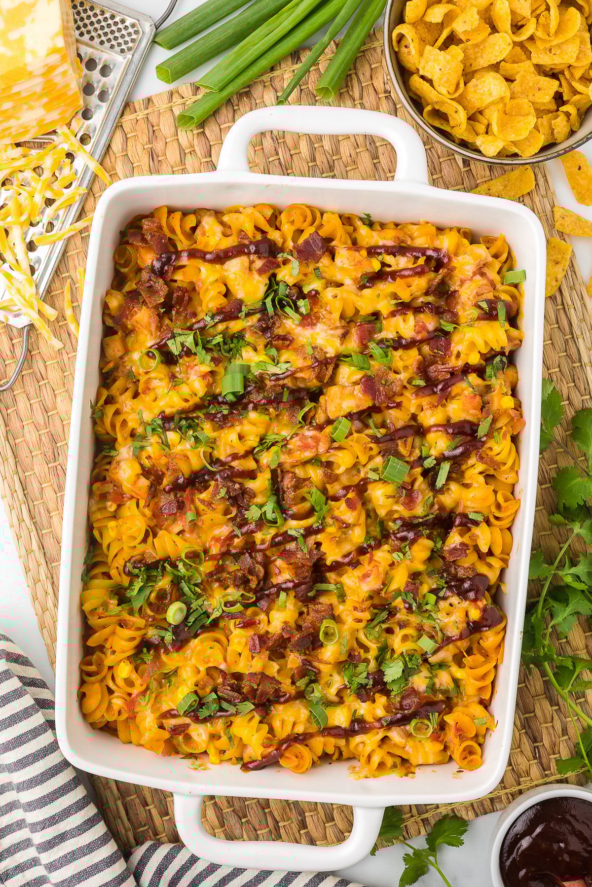 Leftover BBQ Chicken Casserole with cilantro as garnish in a white casserole dish.