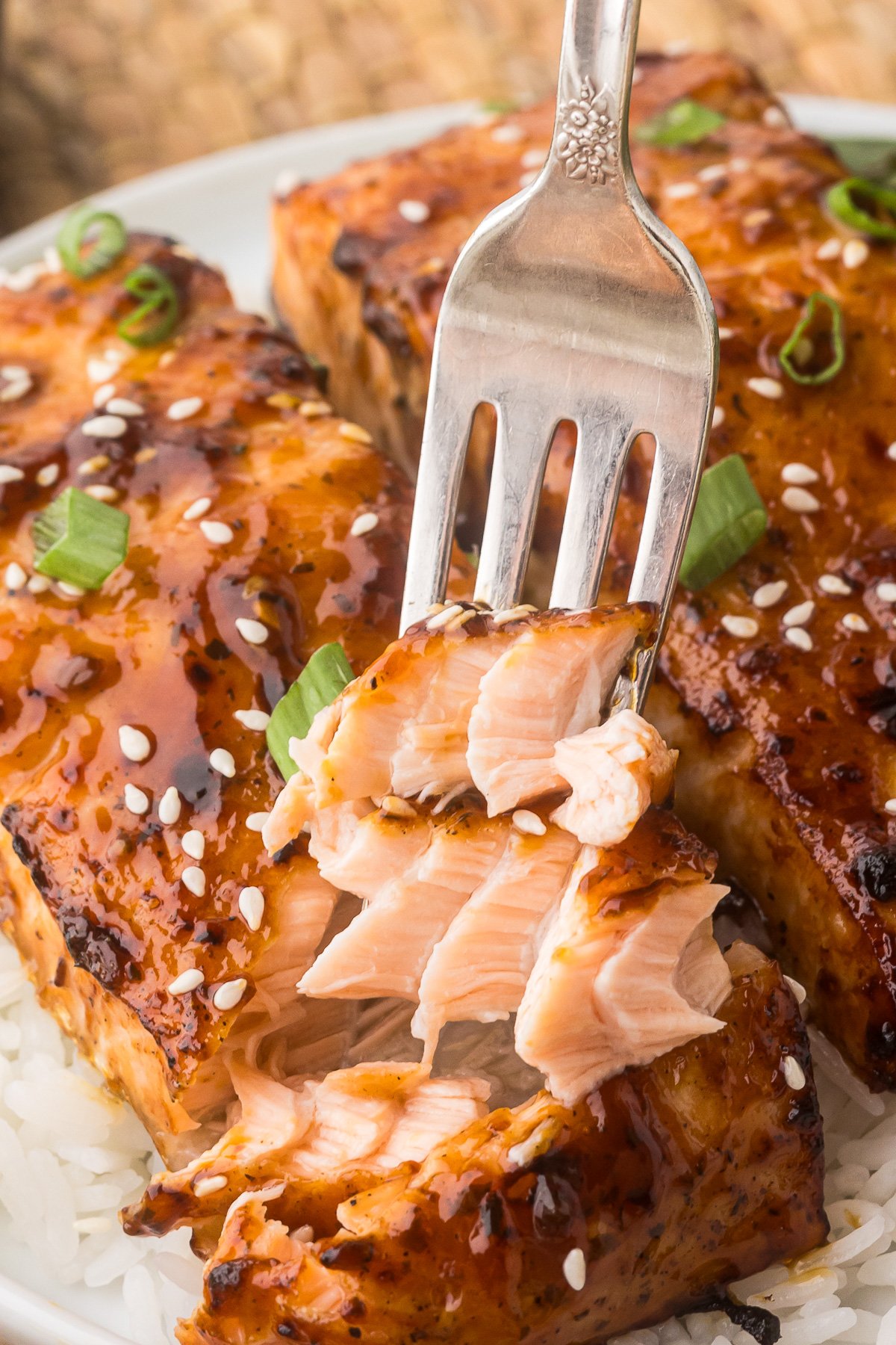 Air Fryer Teriyaki Salmon on a plate with a piece on a fork.
