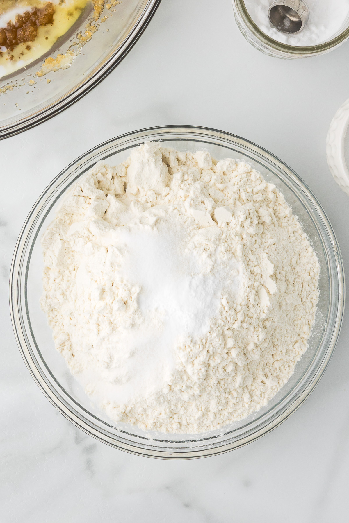 The dry ingredients in a clear bowl for chocolate chip blondies.