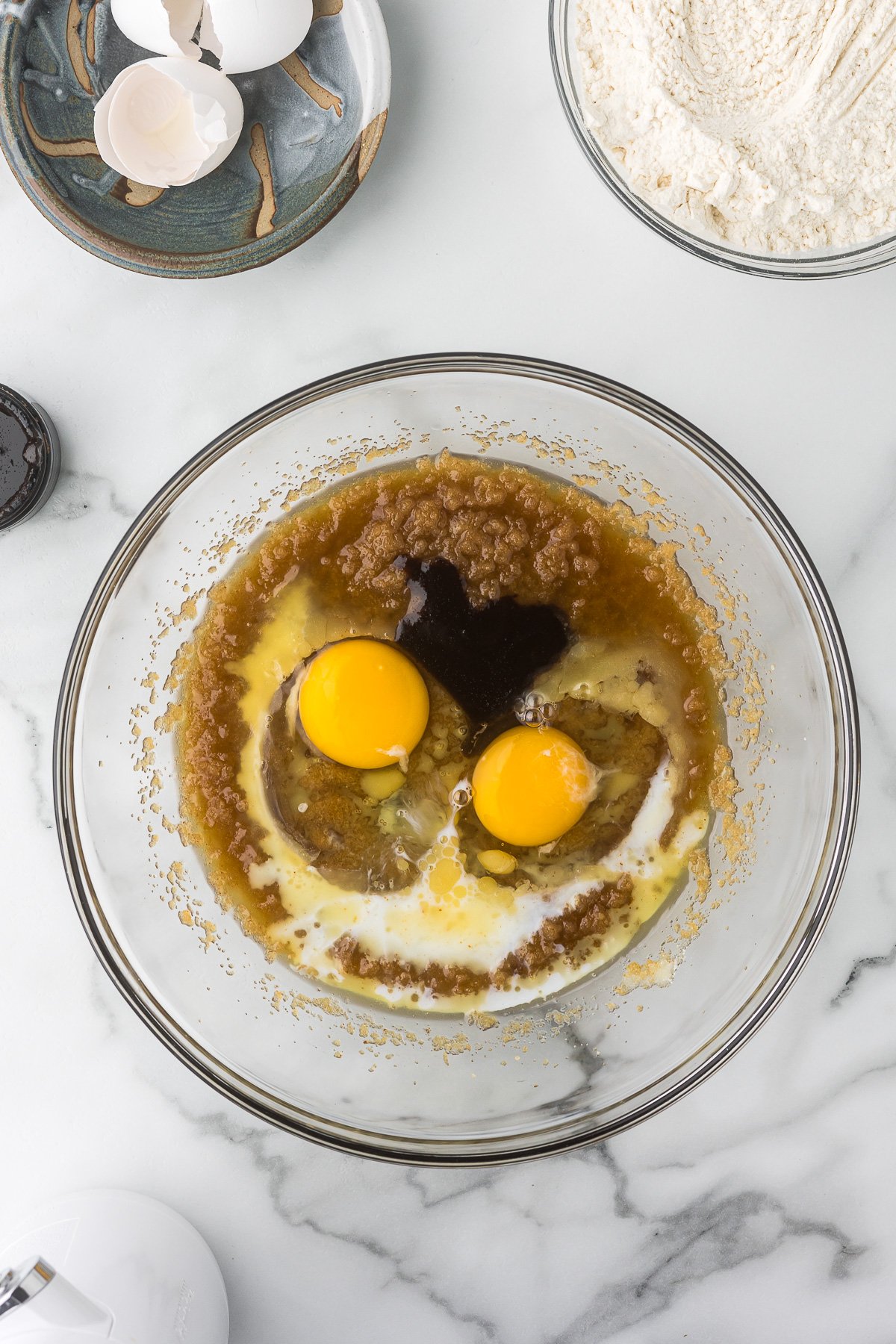 Wet ingredients including eggs for pecan bars.