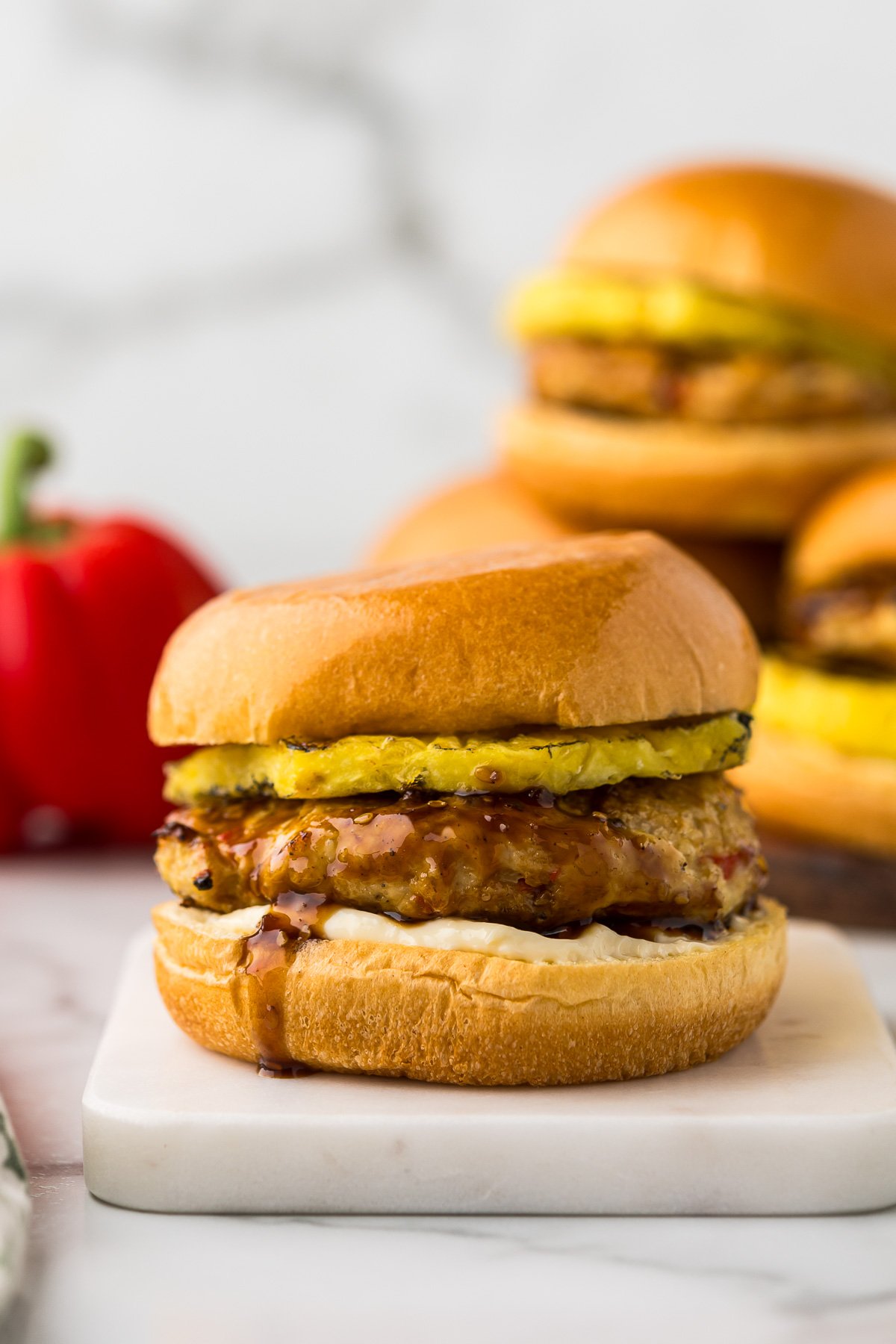 Ground Chicken Burger with pineapple and teriyaki sauce on a bun.
