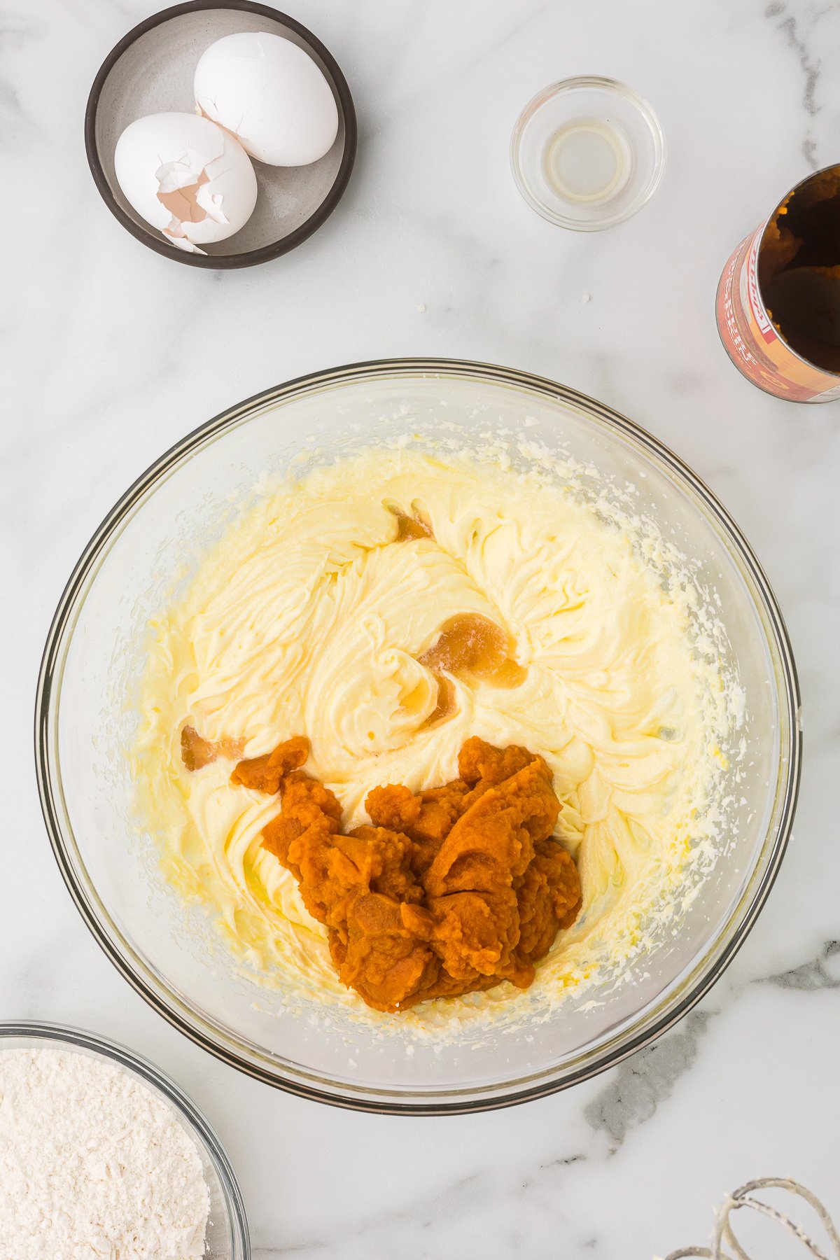 Vanilla and pumpkin being added to the wet ingredients bowl for bread.