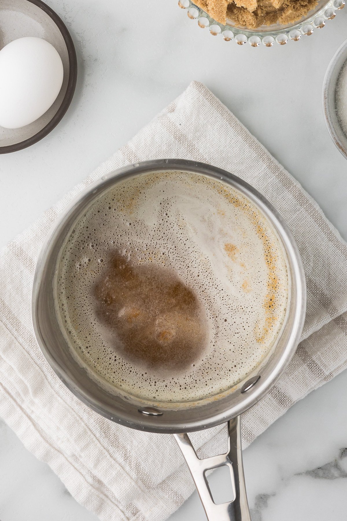 Golden browned butter with toasted milk solids in a saucepan.
