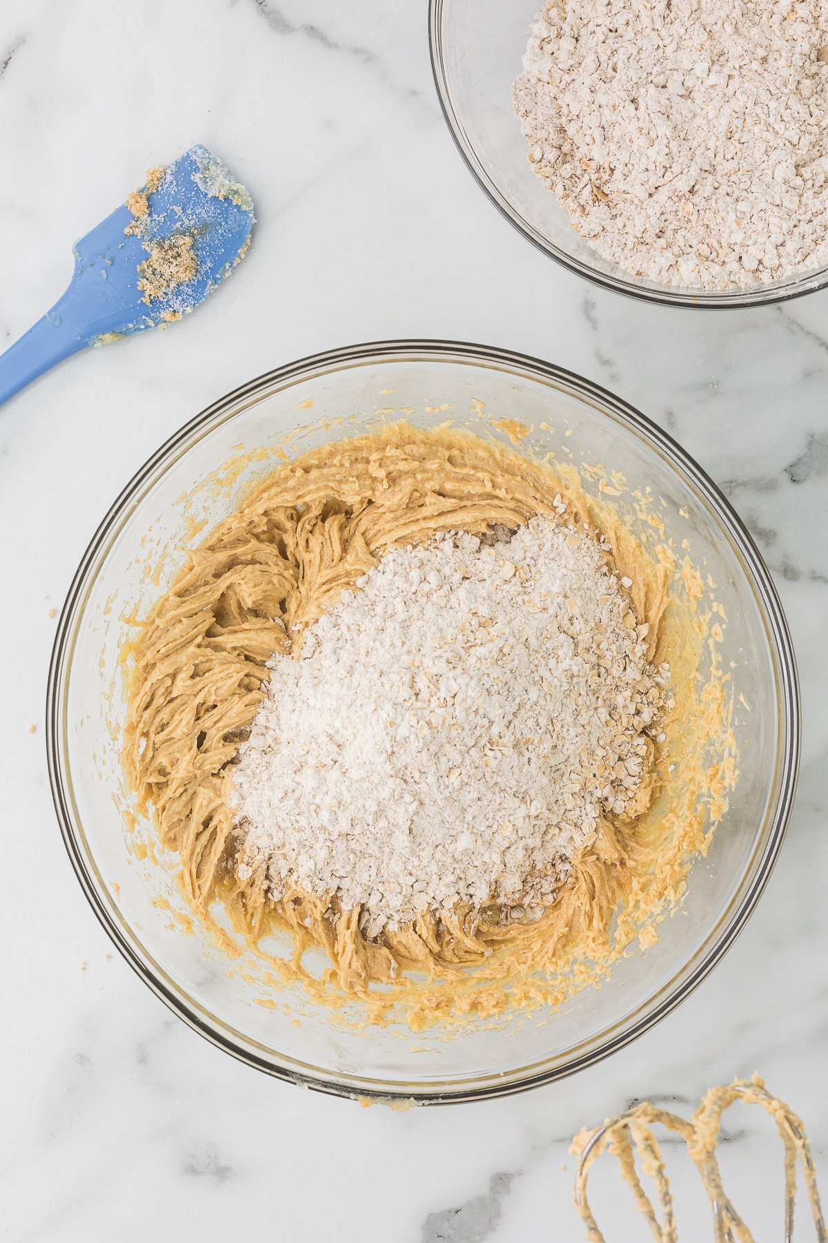 Dry ingredients being folded into the browned-butter mixture for oatmeal cookie dough