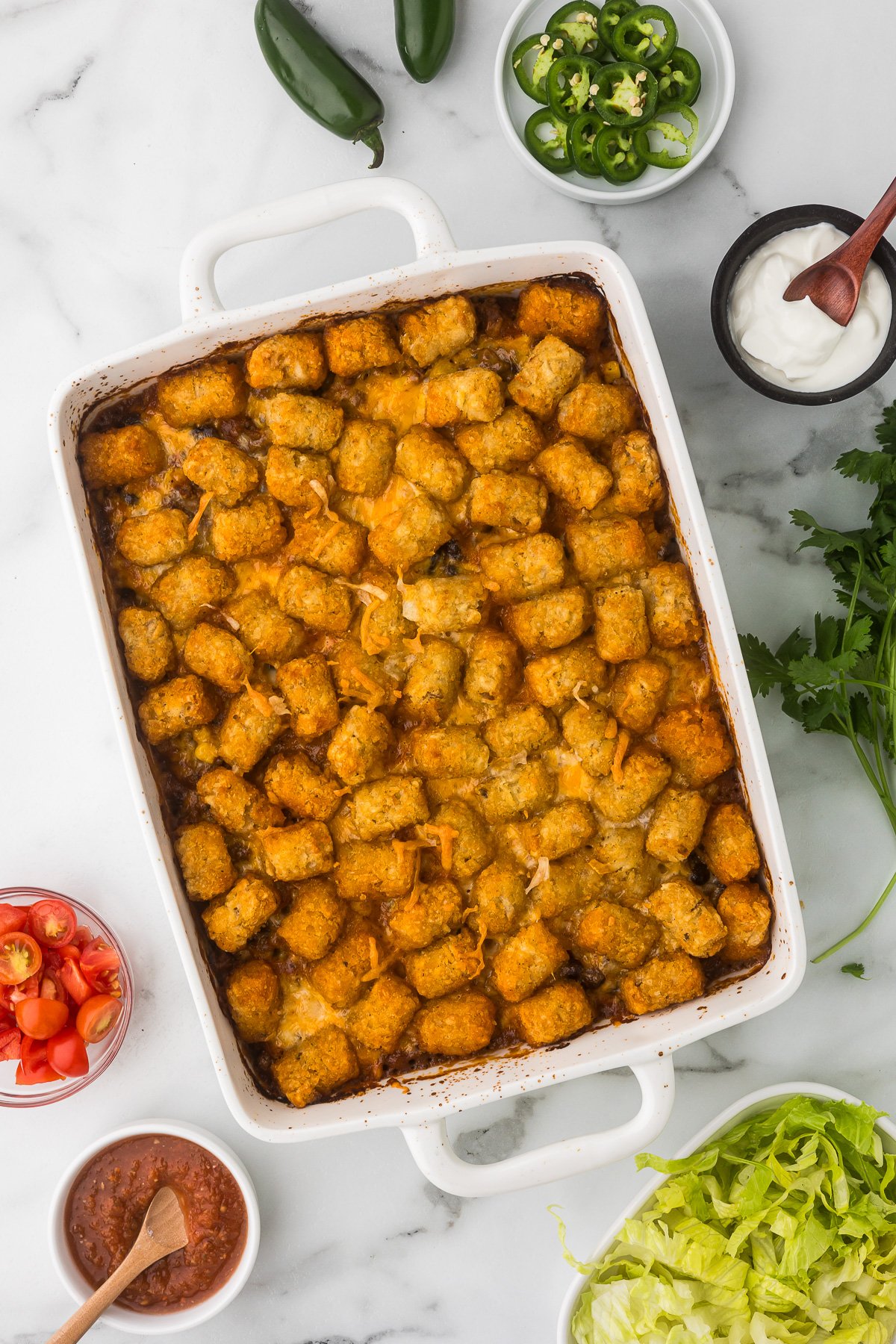 Tater Tot Casserole with taco fixings after it has been baked.