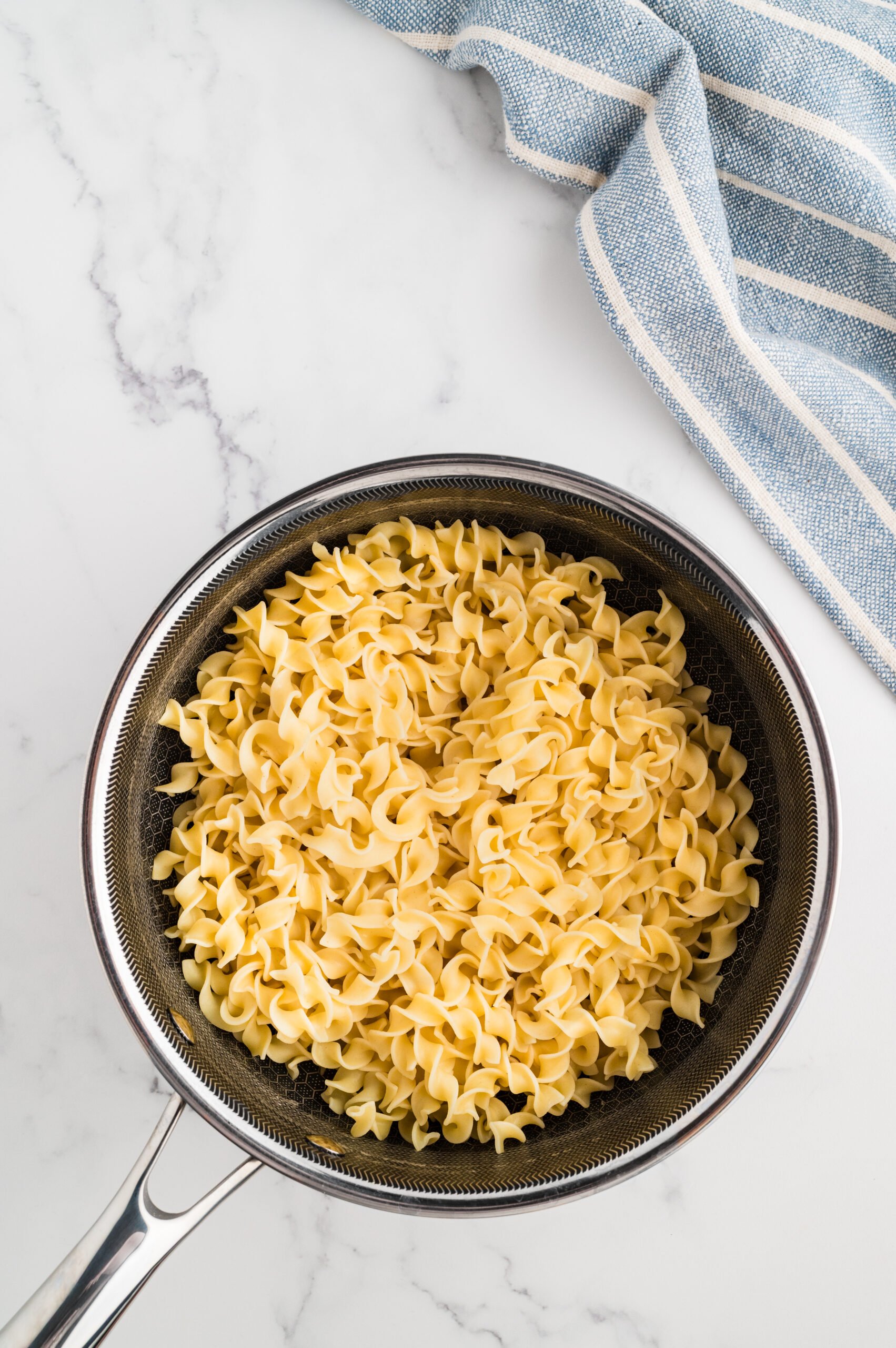 Egg noodles in a pan.