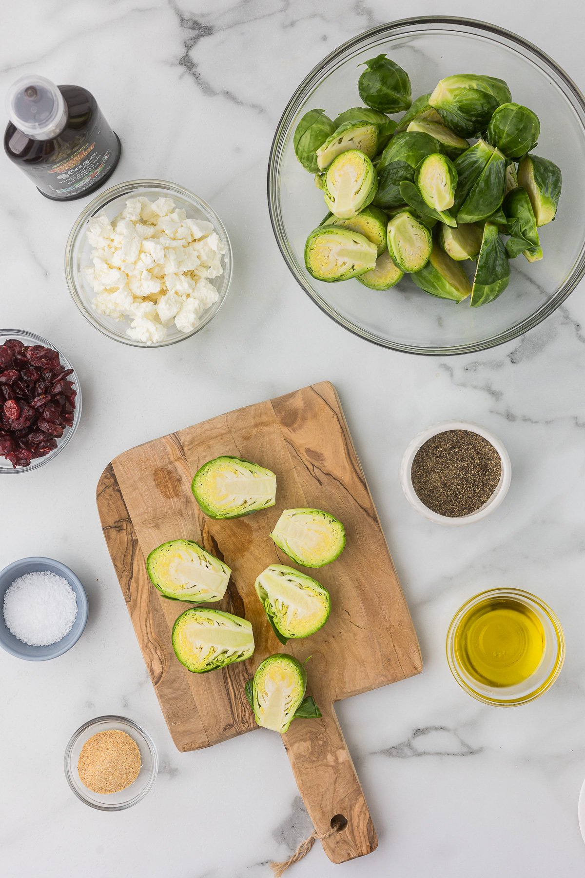 Cut brussels sprouts on a cutting board.