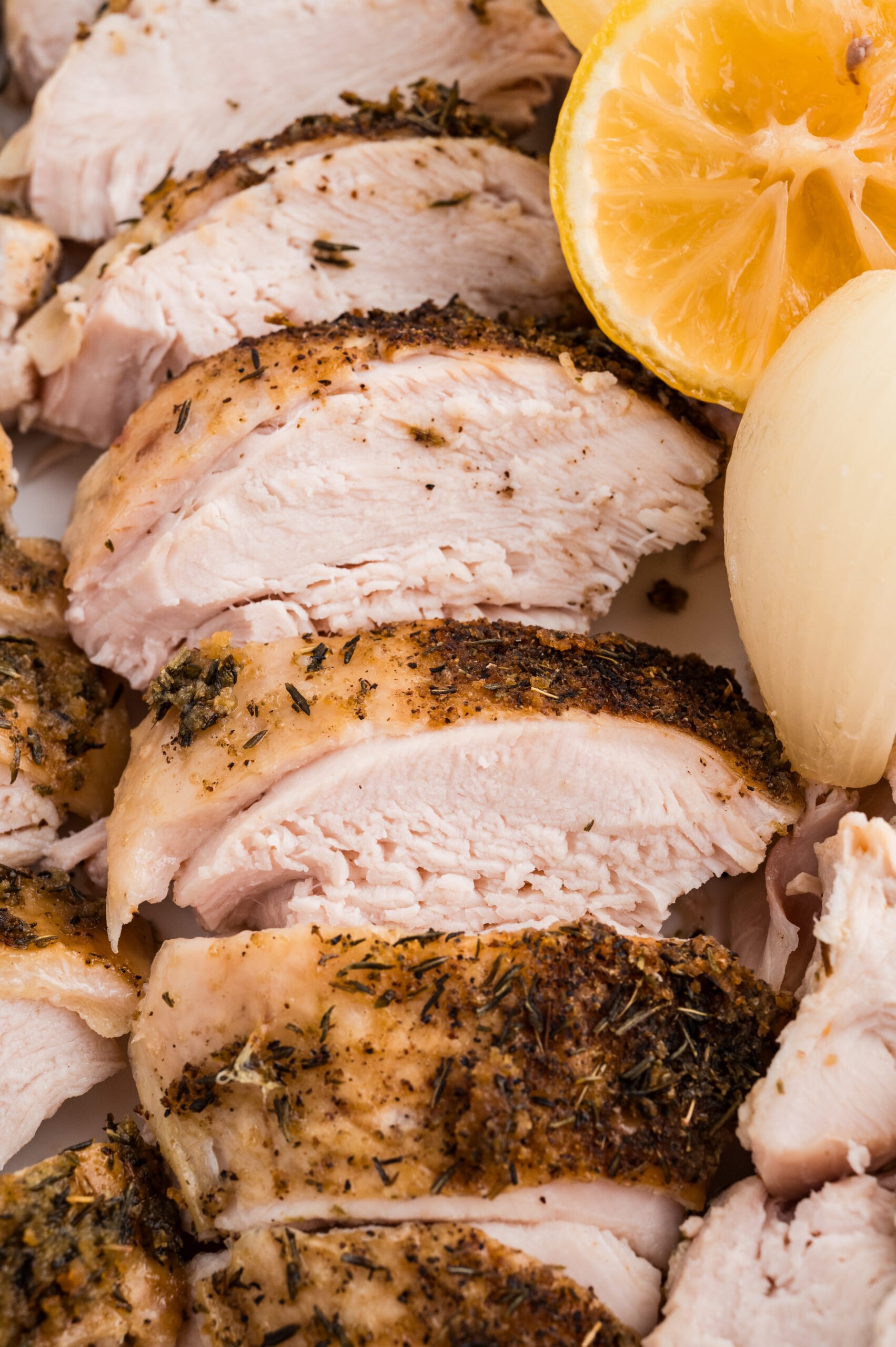 Juicy sliced turkey breast with crispy skin, lemon, and tender onion.