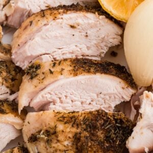 Juicy sliced turkey breast with crispy skin, lemon, and tender onion.