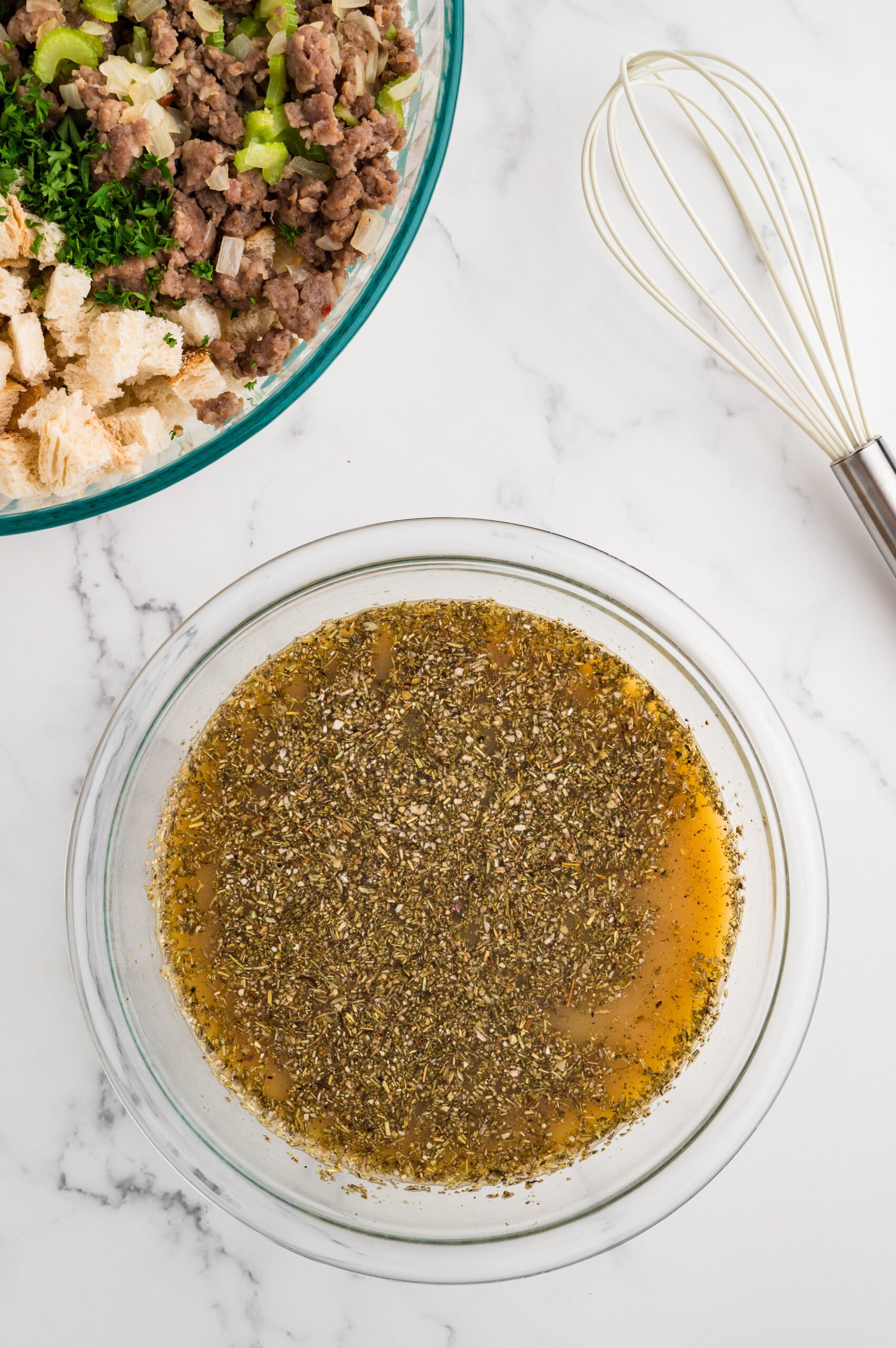Chicken broth whisked with eggs, dried sage, thyme, marjoram, rosemary, nutmeg, black pepper, and kosher salt for sausage stuffing.