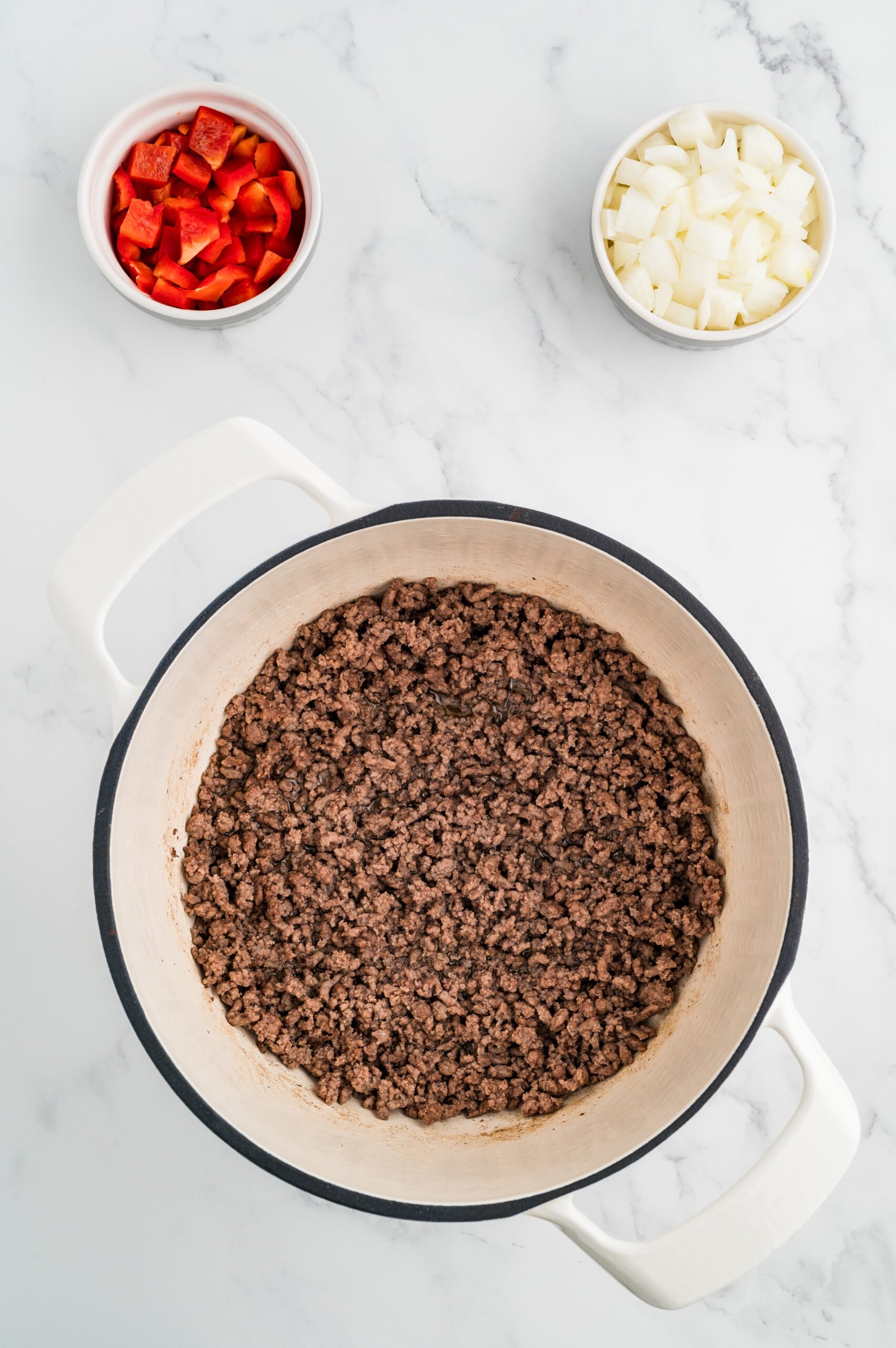 Ground beef browned in a large Dutch oven for cabbage roll soup.