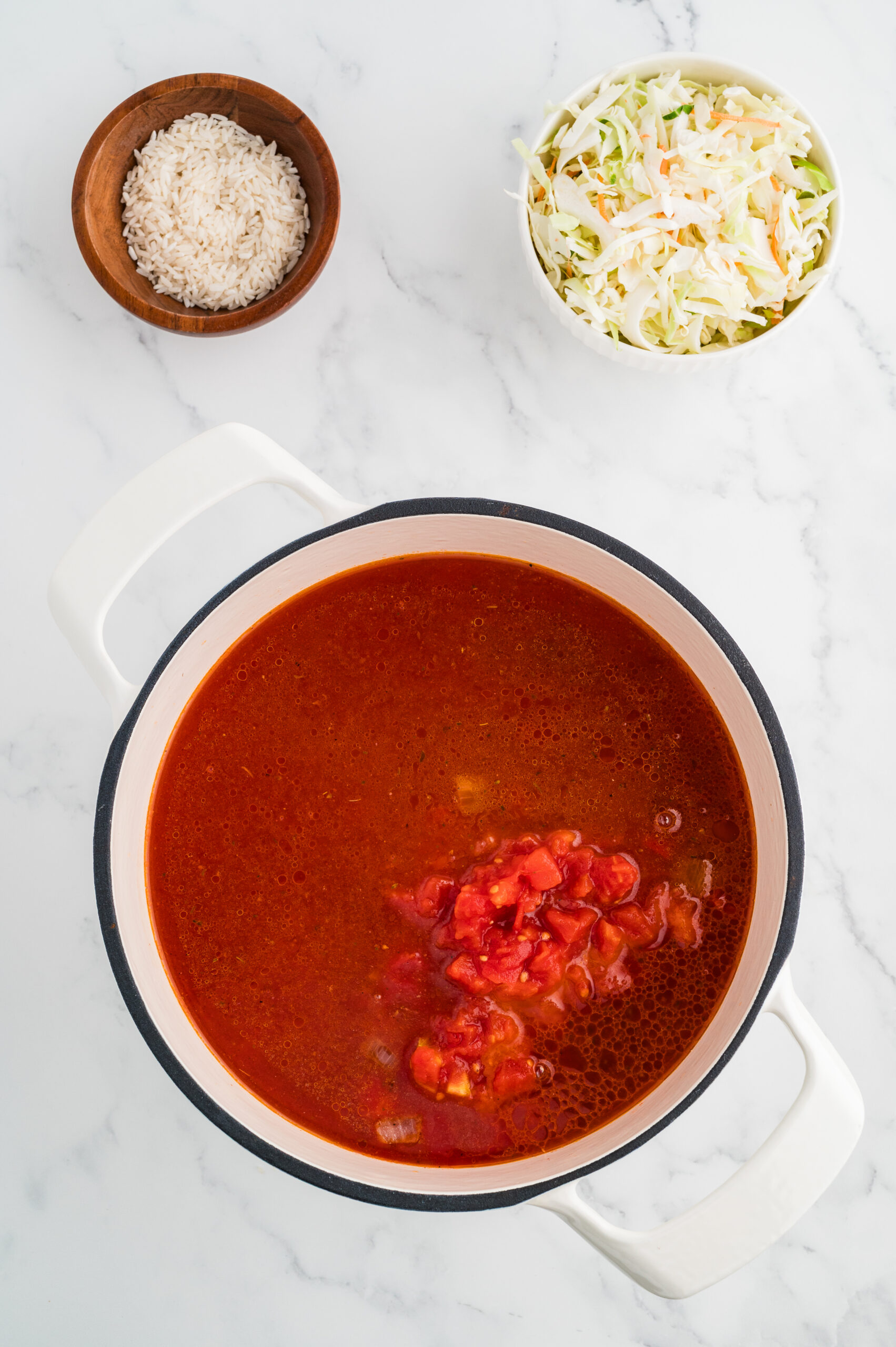 Tomato juice and diced tomatoes added to the pot for cabbage roll soup.