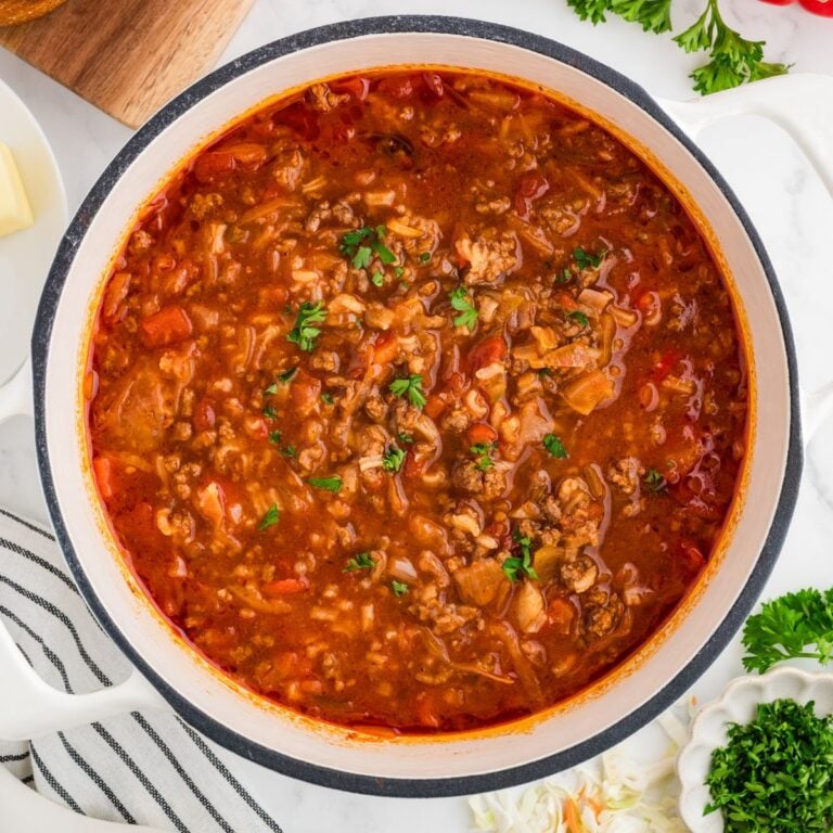 Cabbage Roll Soup in a dutch oven with parsley sprinkled over the top.