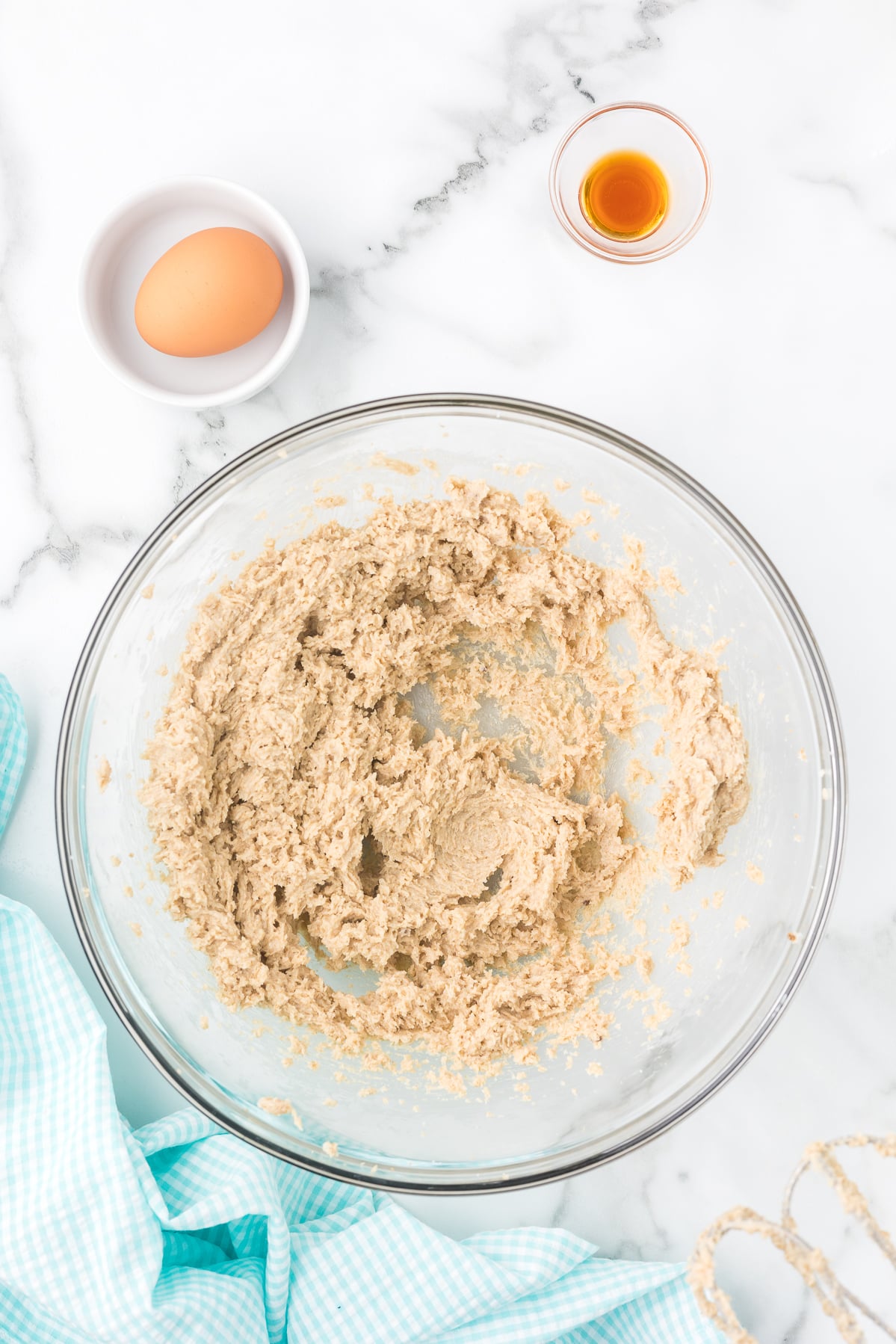 Creamed butter and sugar mixture in a glass bowl for iced cinnamon sugar cookies.