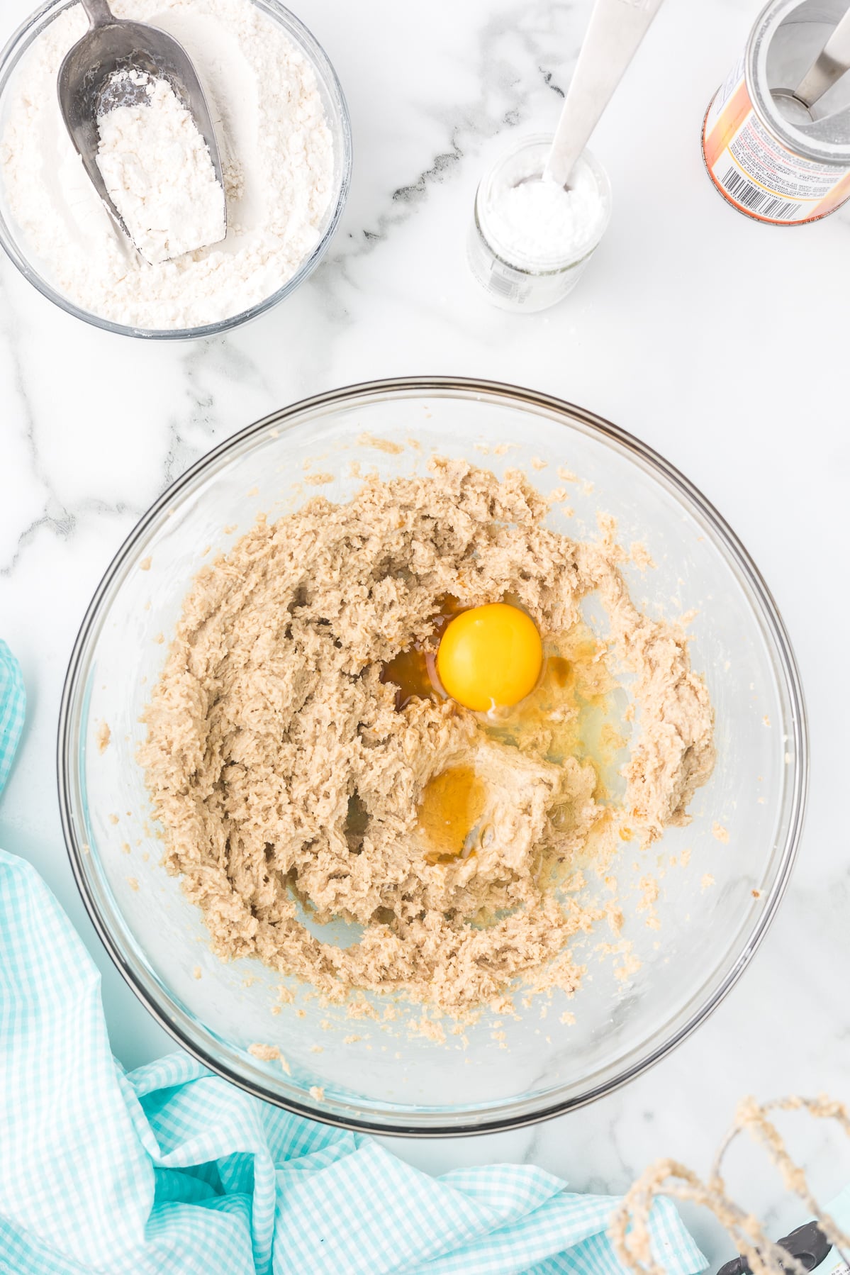 Egg and vanilla added to creamed butter and sugar while making cinnamon sugar cookie dough.