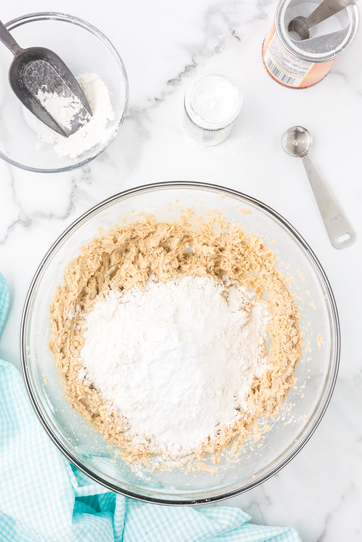 Flour added to cookie dough mixture for soft iced cinnamon sugar cookies.