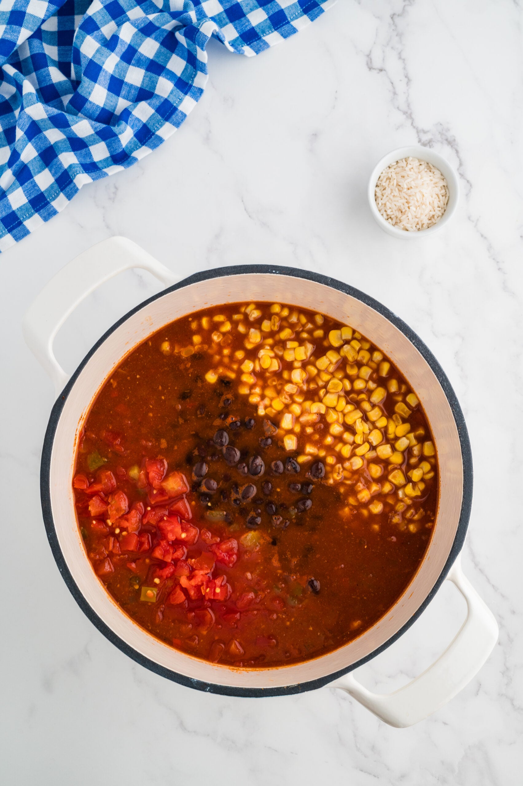 Rotel tomatoes, corn, and black beans added to broth for taco chicken soup.