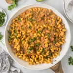 Mexican Mac and Cheese in a skillet with cilantro sprinkled on the top.