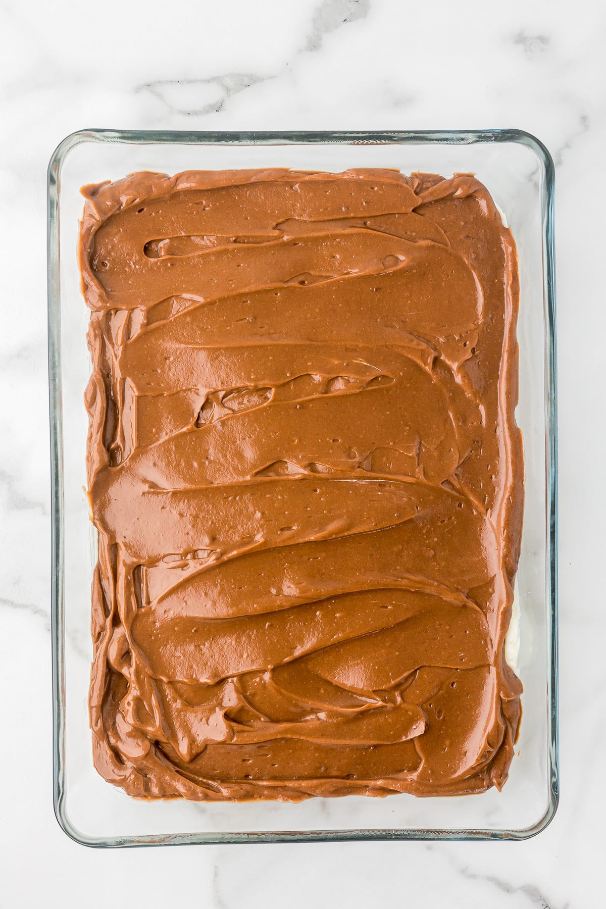 Chocolate pudding layer spread over the cream cheese filling for Chocolate Delight.