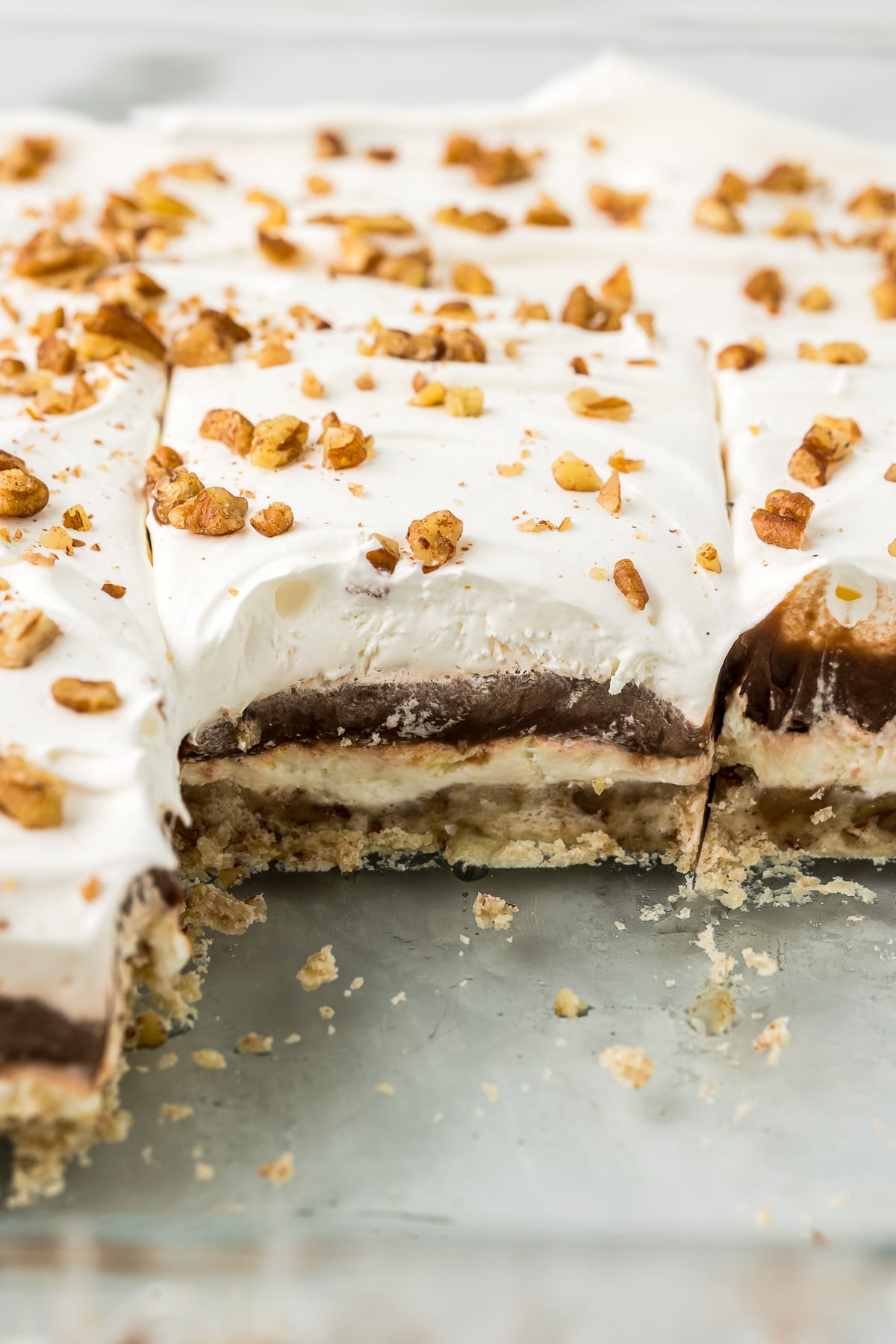Layered dessert with pudding, cream cheese and whipped topping layers.