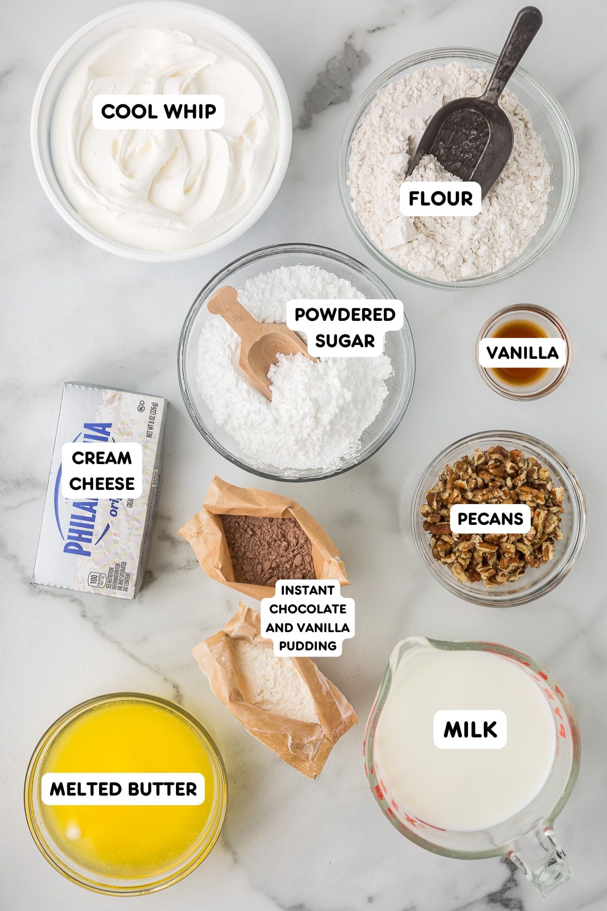 Ingredients for Chocolate Delight including cream cheese, Cool Whip, instant pudding, flour, butter, milk, powdered sugar, vanilla, and pecans.