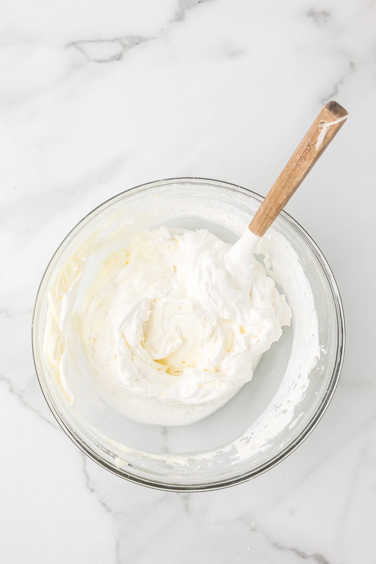 Cream cheese, powdered sugar, and whipped topping mixed until smooth for Chocolate Delight.