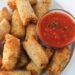 Air fryer cheese sticks on plate with marinara in small bowl